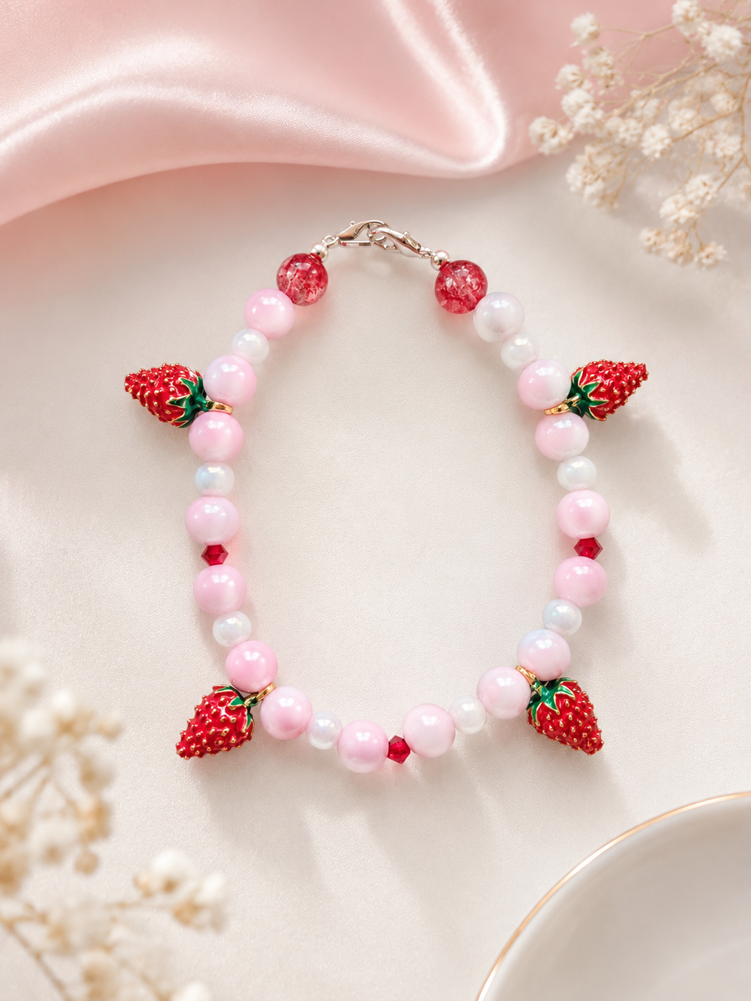 Strawberry beaded bracelet with pink moonstone beads and red enamel strawberry charms